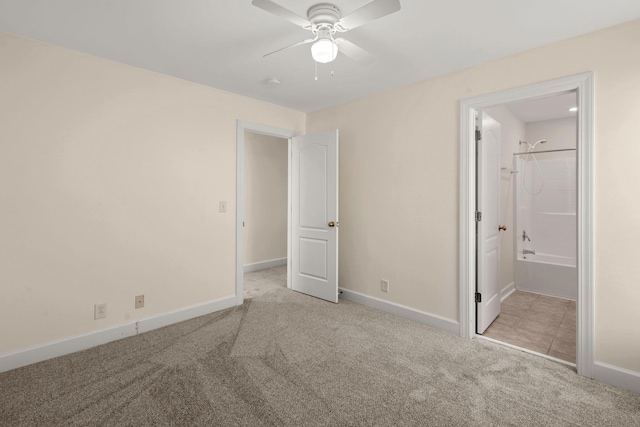 unfurnished bedroom with ceiling fan, light colored carpet, and ensuite bath