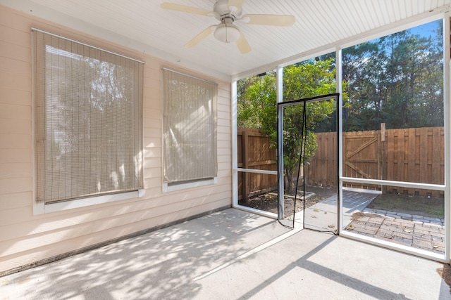 unfurnished sunroom with ceiling fan