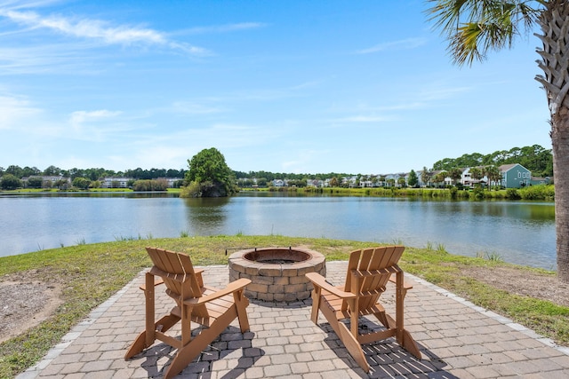 view of patio / terrace featuring a water view and a fire pit