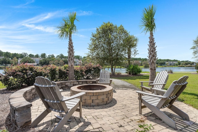 view of patio / terrace with a fire pit and a water view