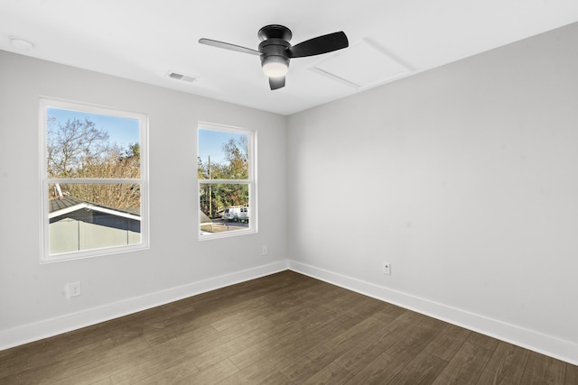 empty room with dark hardwood / wood-style floors and ceiling fan