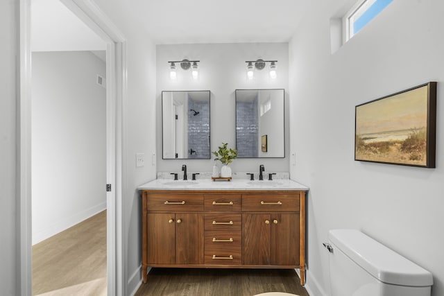 bathroom with hardwood / wood-style floors, vanity, and toilet