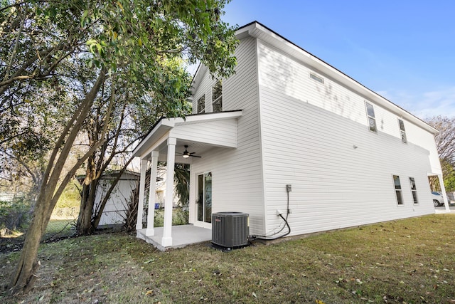 view of side of property with a yard, central AC, ceiling fan, and a patio area