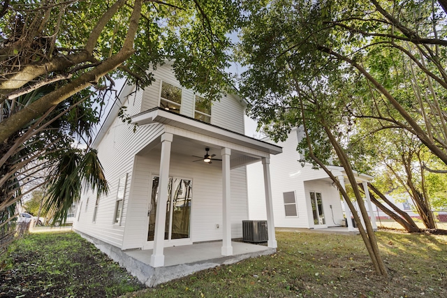 back of property featuring ceiling fan, cooling unit, a patio area, and a yard