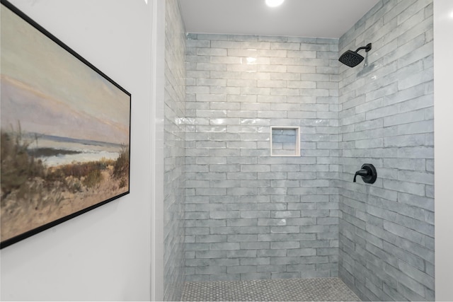 bathroom with tiled shower