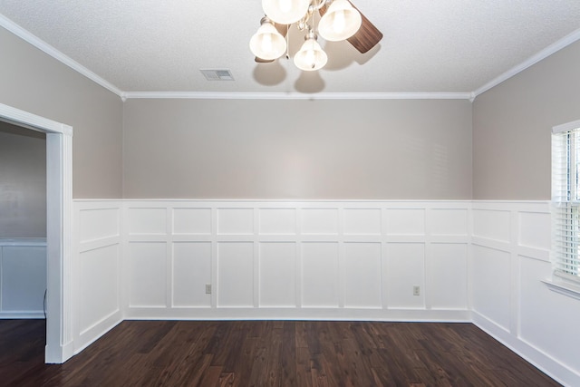 unfurnished dining area featuring dark wood-type flooring, a textured ceiling, and crown molding