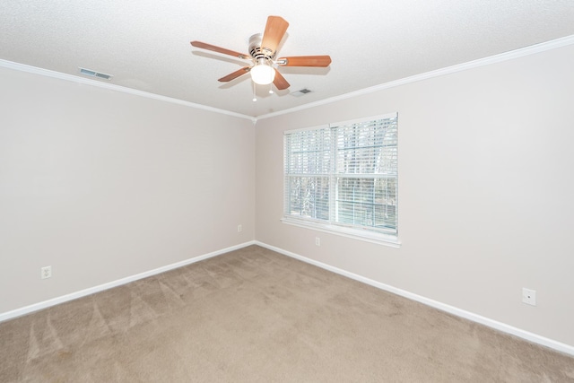 spare room with a textured ceiling, light carpet, ceiling fan, and crown molding