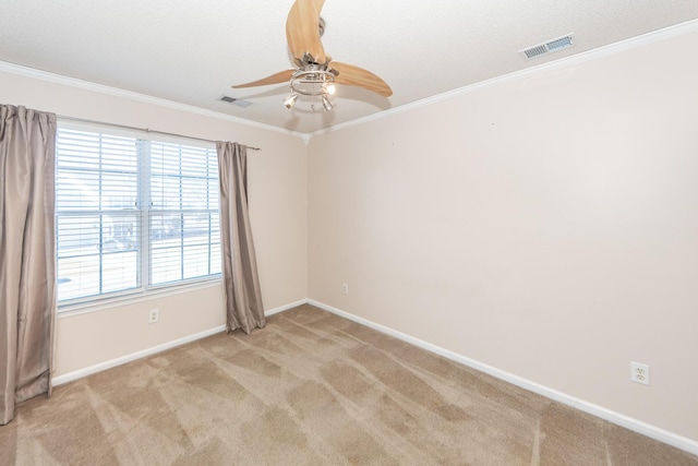 carpeted spare room with ornamental molding and ceiling fan