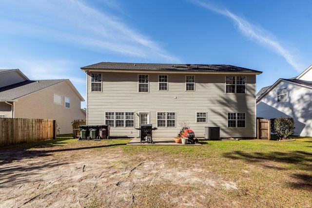 rear view of property with a yard and a patio area