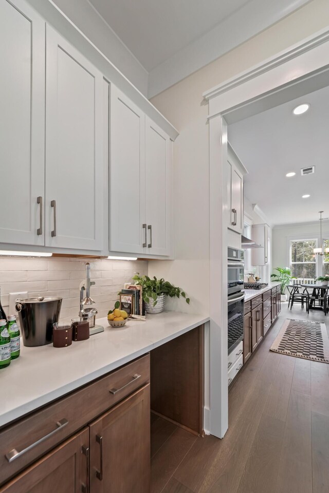 4235 Royal Harbor Rd, Hollywood, SC 29449 - kitchen with light countertops, backsplash, dark wood-type flooring, visible vents, and appliances with stainless steel finishes