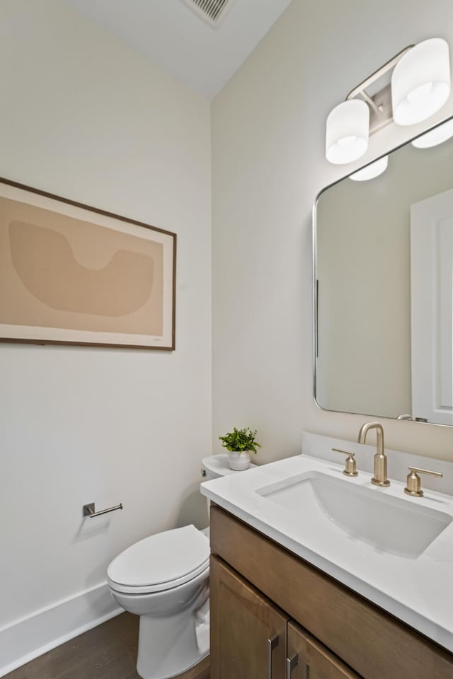 4235 Royal Harbor Rd, Hollywood, SC 29449 - bathroom featuring vanity, visible vents, toilet, wood finished floors, and baseboards