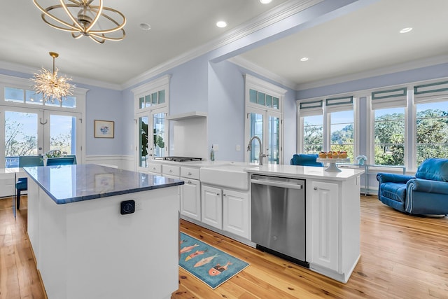 kitchen featuring a kitchen island, a chandelier, dishwasher, french doors, and white cabinets