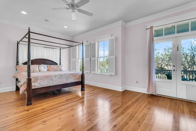 bedroom with baseboards, light wood finished floors, french doors, crown molding, and access to outside