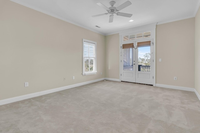 spare room featuring plenty of natural light, baseboards, and ornamental molding