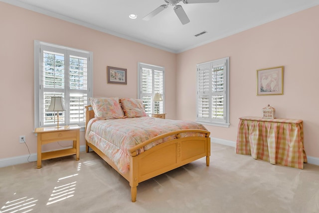 carpeted bedroom featuring visible vents, crown molding, baseboards, recessed lighting, and a ceiling fan