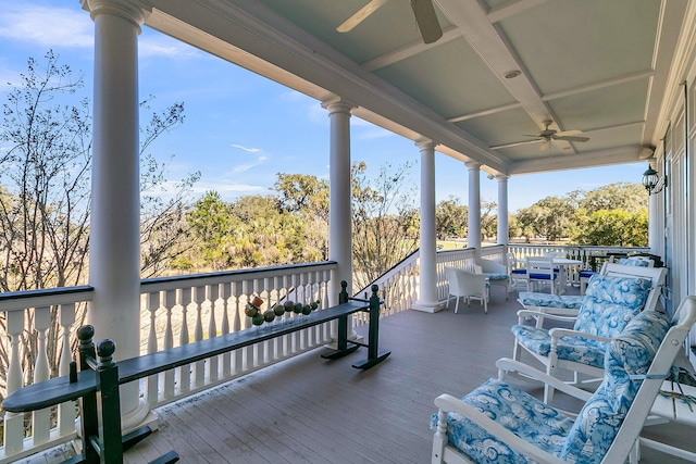 wooden deck featuring outdoor dining area and a ceiling fan