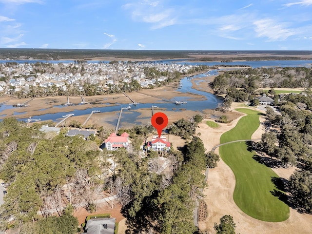 drone / aerial view featuring golf course view and a water view