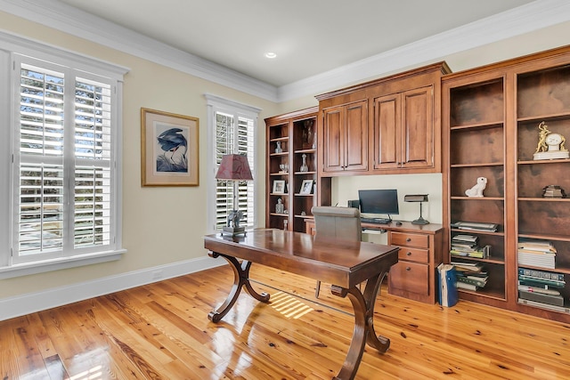 home office featuring plenty of natural light, light wood-type flooring, crown molding, and baseboards