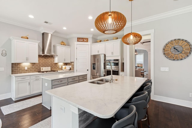 525 Yellow Tower Ter, Charleston, SC 29412 - kitchen with wall chimney range hood, a kitchen island with sink, appliances with stainless steel finishes, white cabinets, and tasteful backsplash