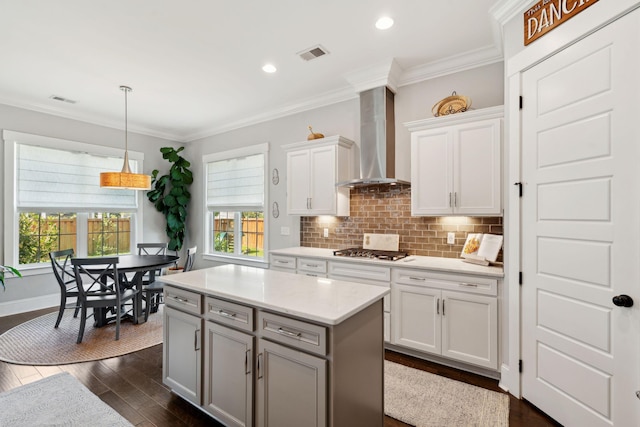 525 Yellow Tower Ter, Charleston, SC 29412 - kitchen with wall chimney range hood, healthy amount of natural light, dark wood finished floors, tasteful backsplash, and crown molding