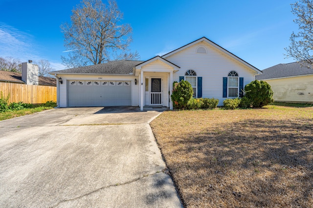 single story home featuring an attached garage, fence, concrete driveway, and a front yard