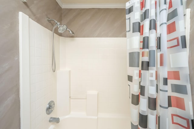 bathroom featuring ornamental molding and shower / tub combo