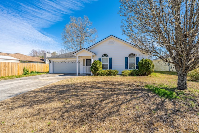 ranch-style house featuring concrete driveway, an attached garage, fence, and a front yard