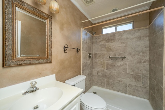 full bath with visible vents, vanity, toilet, and tiled shower