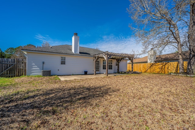 rear view of property with a fenced backyard, a lawn, a pergola, and a patio