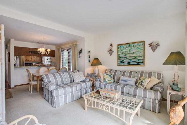 carpeted living room featuring a chandelier and baseboards