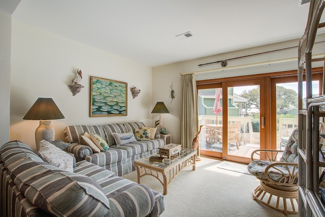 carpeted living area featuring visible vents