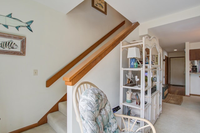 stairs featuring carpet flooring and baseboards