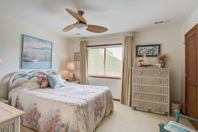 bedroom featuring ceiling fan, carpet floors, a closet, and visible vents