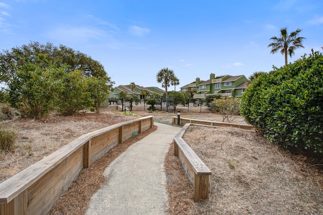 view of yard featuring a garden, a residential view, and fence