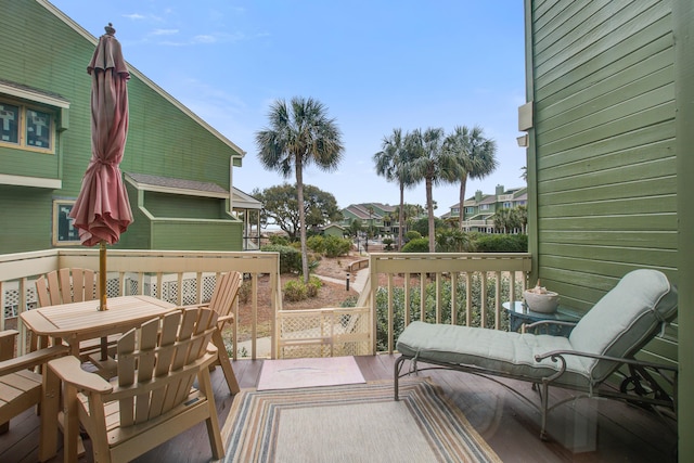 wooden terrace featuring outdoor dining area