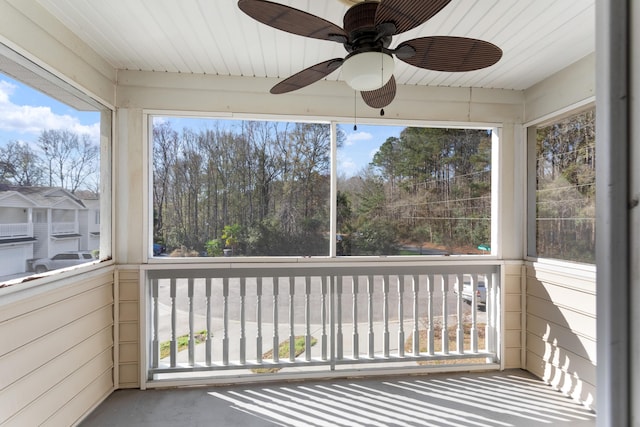 unfurnished sunroom featuring ceiling fan