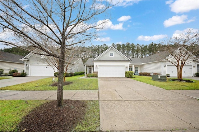 view of front of home featuring an attached garage, concrete driveway, and a front yard