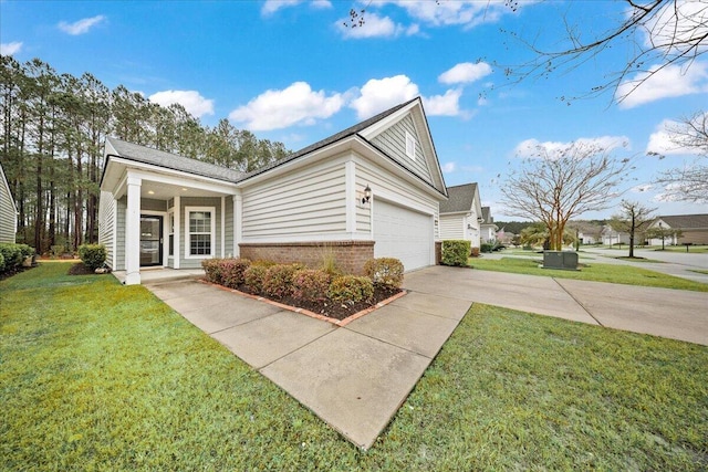 ranch-style home with brick siding, an attached garage, a front lawn, a porch, and driveway