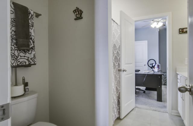 bathroom with tile patterned flooring, ceiling fan, and toilet