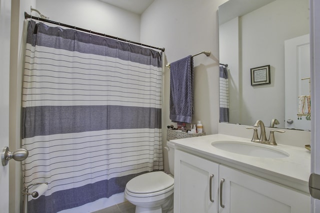 bathroom featuring curtained shower, tile patterned flooring, vanity, and toilet