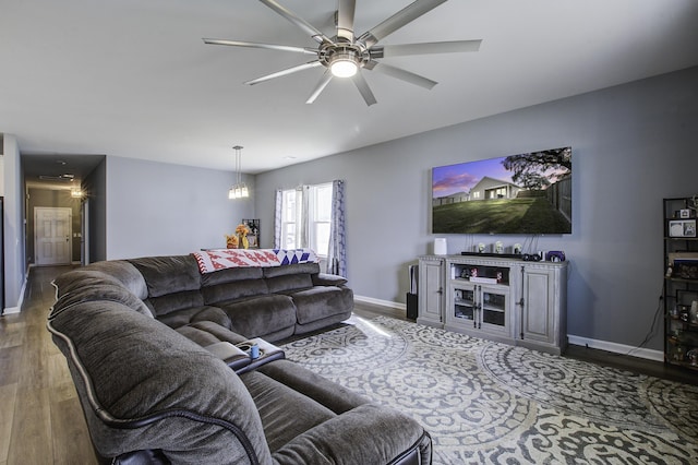 living room featuring ceiling fan with notable chandelier and dark hardwood / wood-style floors