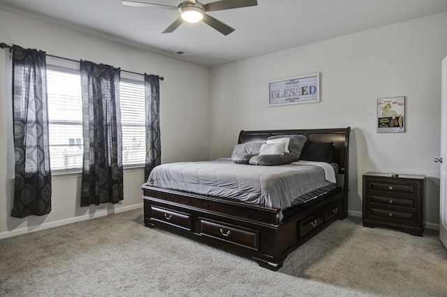 bedroom with ceiling fan and light carpet