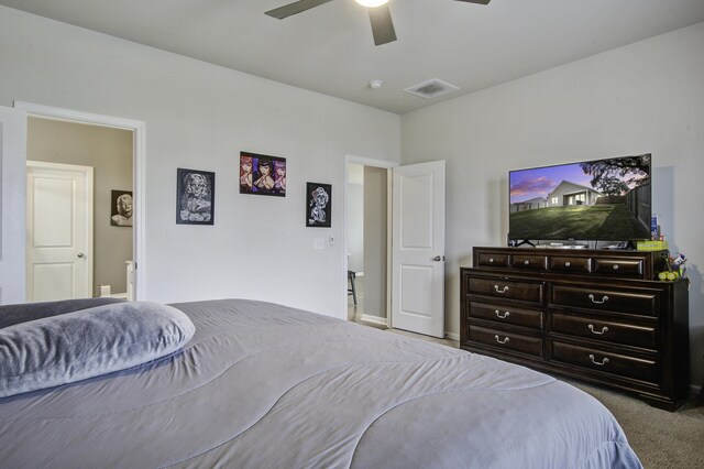 bedroom with carpet floors, ceiling fan, and connected bathroom