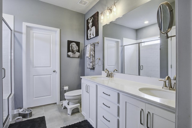 bathroom with a shower with door, vanity, and toilet