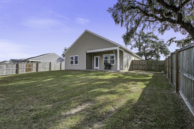 rear view of house with a yard