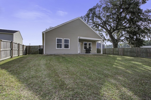 back of house featuring a lawn