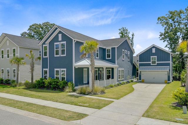 2557 Hatch Dr, Johns Island, SC 29455 - view of front facade featuring board and batten siding, a garage, concrete driveway, and a front lawn