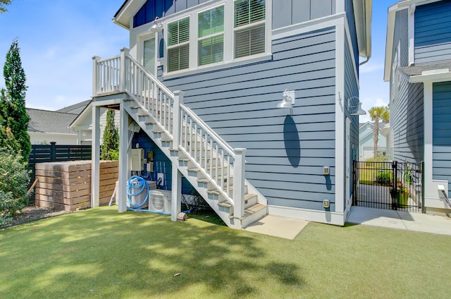 2557 Hatch Dr, Johns Island, SC 29455 - back of house featuring stairs, board and batten siding, fence, and a yard