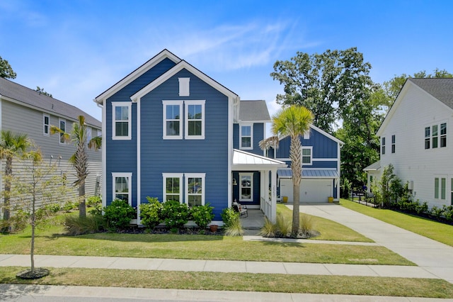 2557 Hatch Dr, Johns Island, SC 29455 - view of front of home with board and batten siding, an attached garage, driveway, and a front lawn
