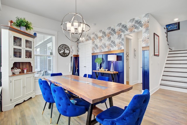 2557 Hatch Dr, Johns Island, SC 29455 - dining area with light wood-style floors, baseboards, a chandelier, and stairway